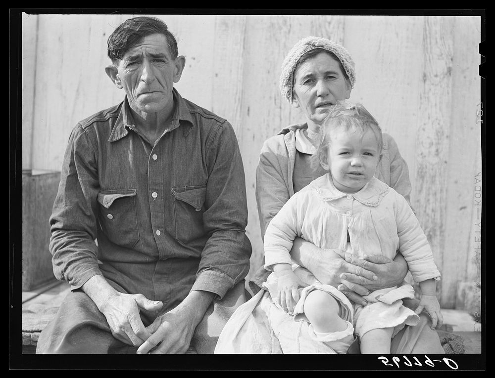 Spanish muskrat trapper, his wife and their adopted child by their marsh camp. Delacroix Island, Saint Bernard Parish…
