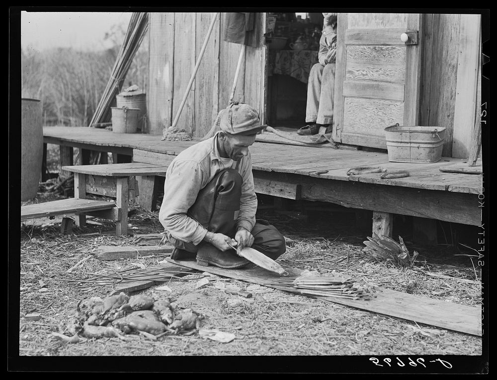 [Untitled photo, possibly related to: Spanish muskrat trapper in doorway of his marsh camp. Delacroix Island, Saint Bernard…