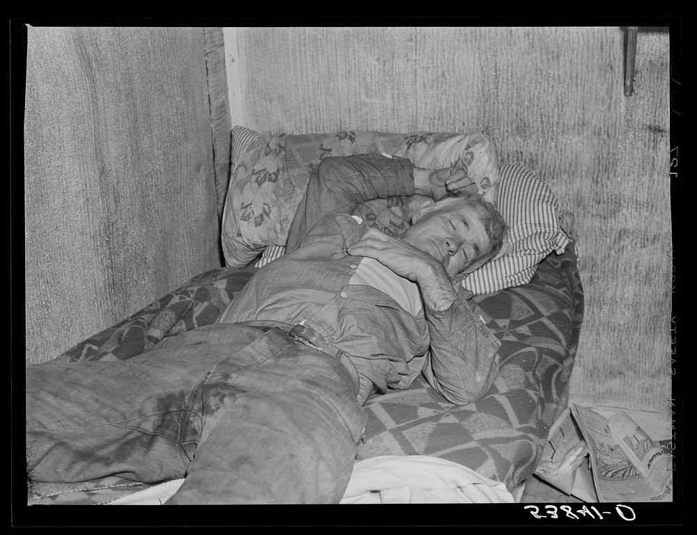 Spanish muskrat trapper on his camp bed after too much whiskey and red wine. Delacroix Island, Saint Bernard Parish…