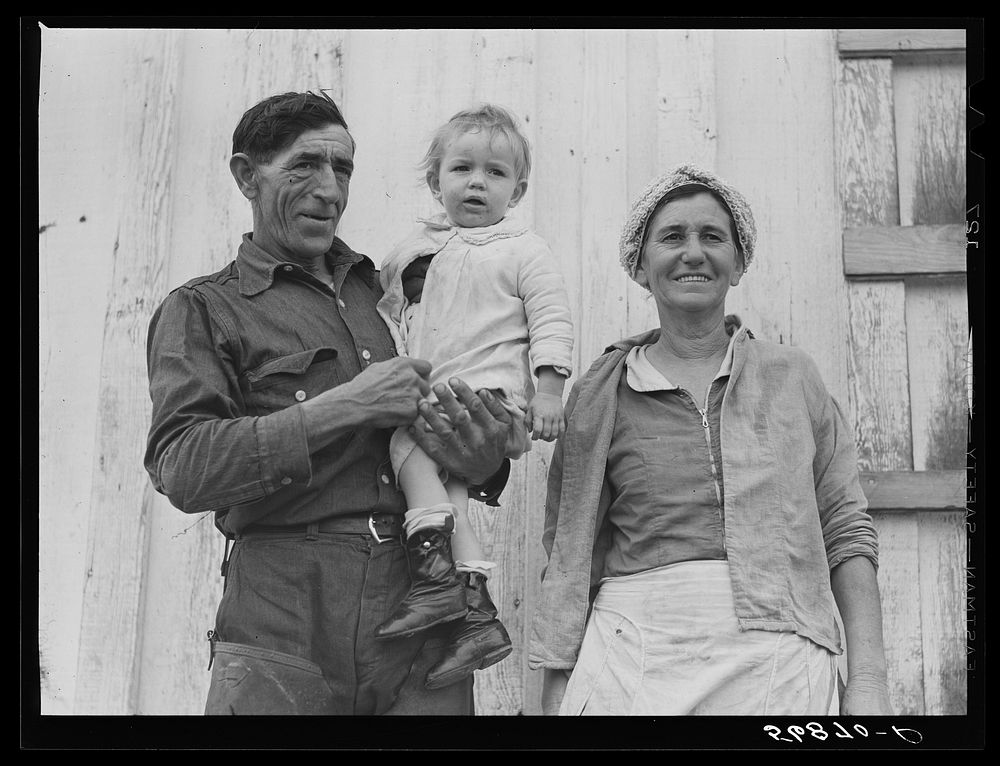 Spanish muskrat trapper, his wife and their adopted child by their marsh camp. Delacroix Island, Saint Bernard Parish…