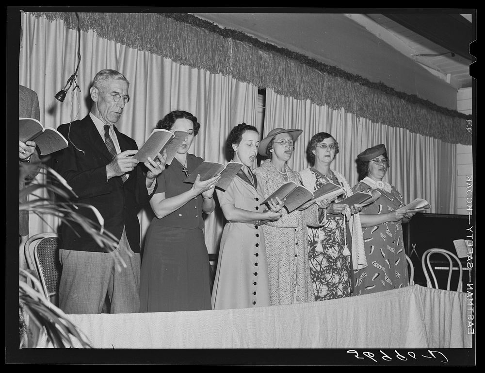 Choir singing at Sunday church service held in Sarasota trailer park. Sarasota, Florida. Sourced from the Library of…