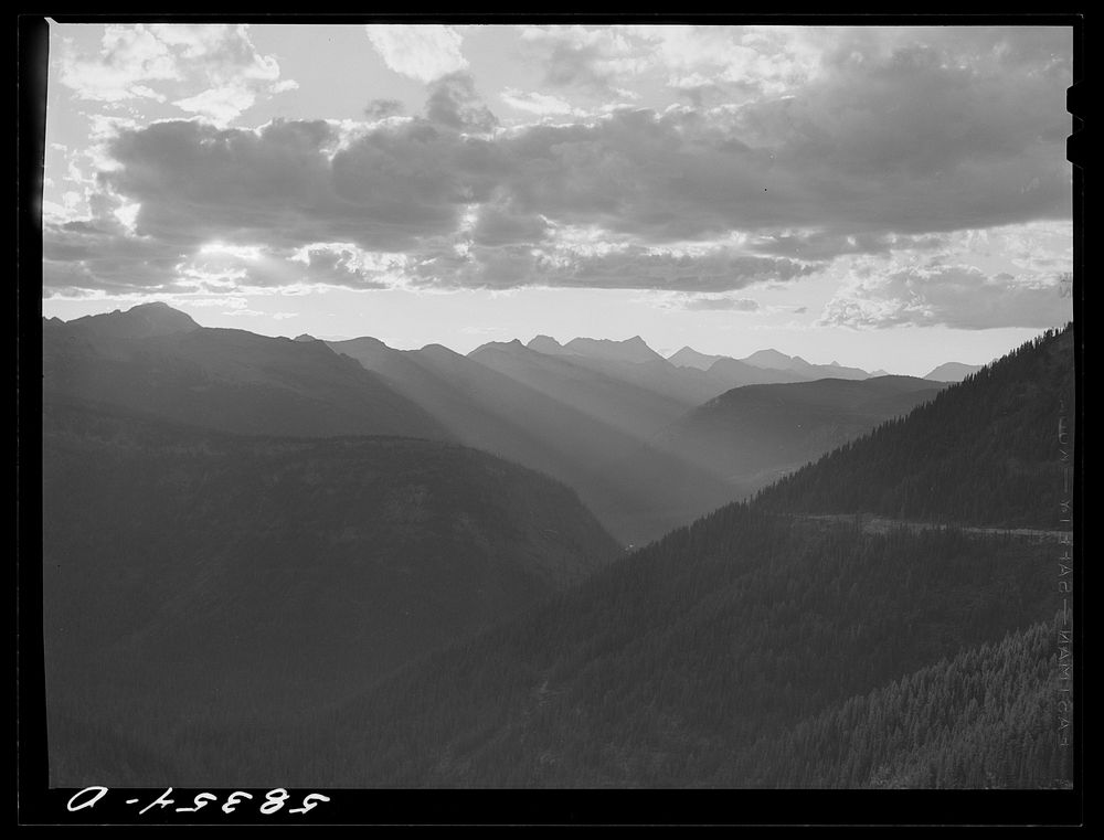 General view of Rocky Mountains at sundown west of Continental Divide seen from top of Logan Pass en route to the Sun…