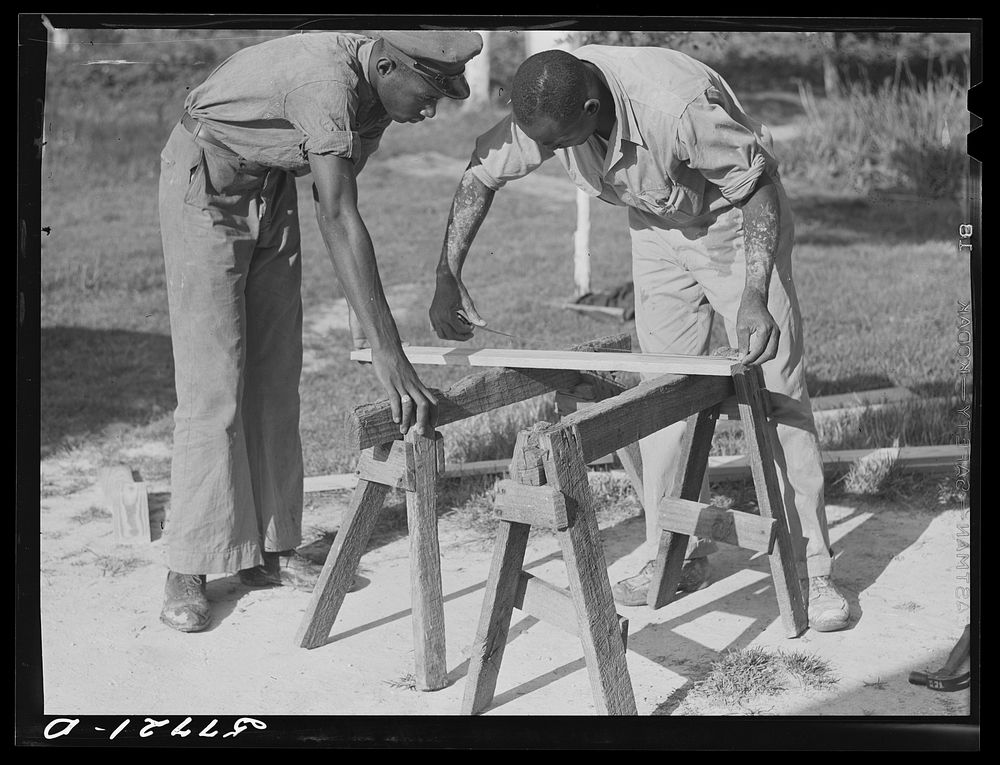 Measuring the top piece. Demonstration of home screen door construction. Saint Mary's County, Ridge, Maryland. Sourced from…