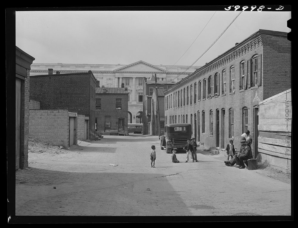 Schoots Court with Senate building in background. Four very small dark rooms rent for fifteen and eighteen dollars per month…