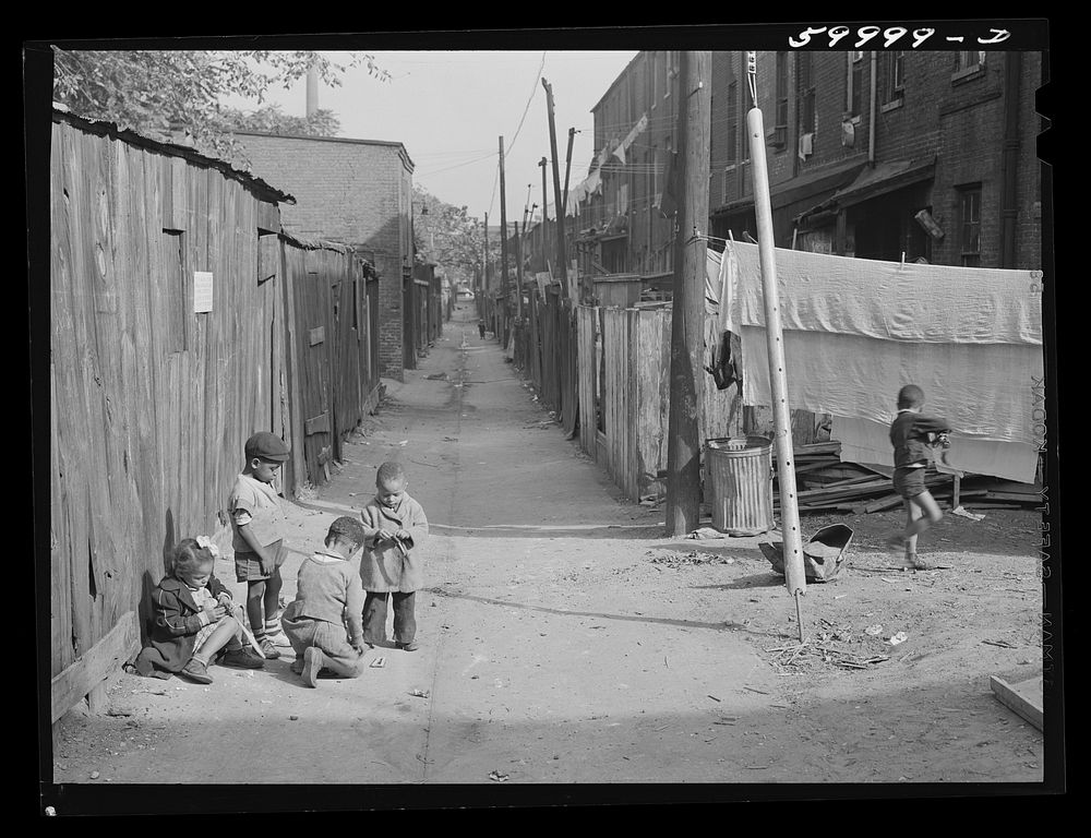 Children playing in De Frees Alley, N.E. Washington, D.C., near Capitol building. One basement room rents for nine dollars a…