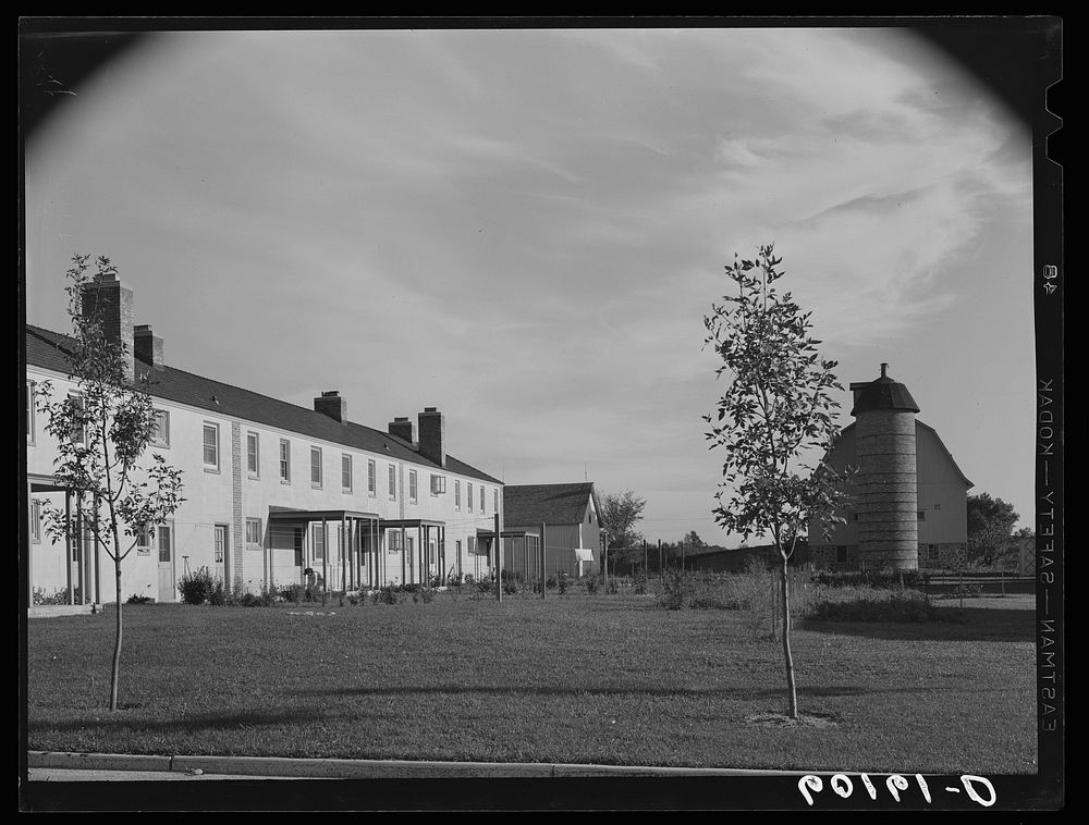 Apartment houses at Greendale, Wisconsin. Old barn on right is used for playhouse. Sourced from the Library of Congress.