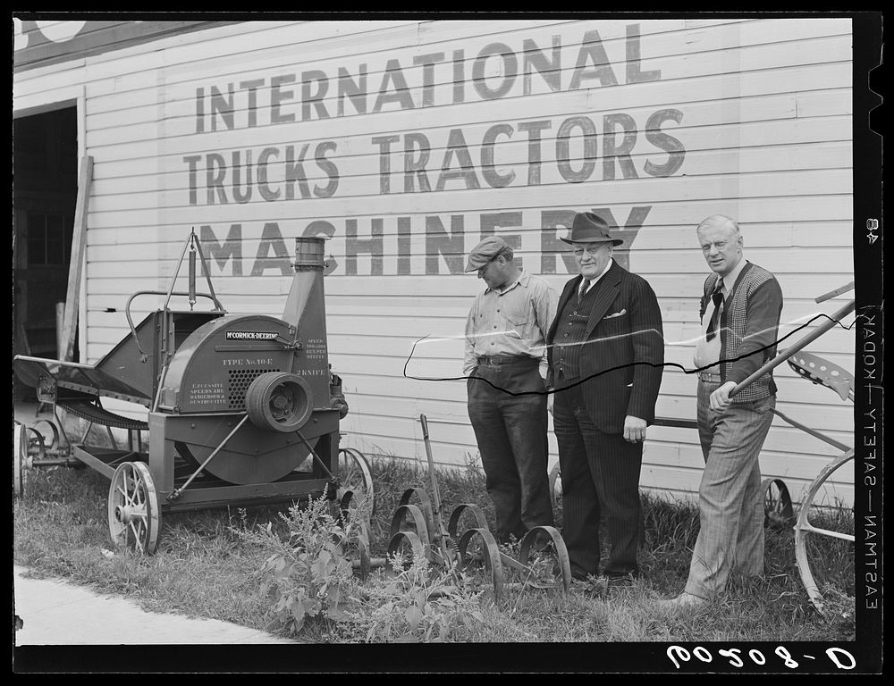 [Untitled photo, possibly related to: County supervisor (FSA) looking over used farm machinery with FSA (Farm Security…