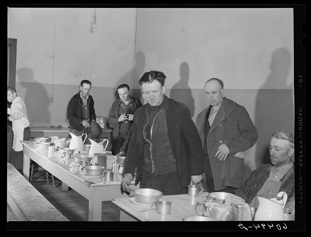 Men filing into dining hall at 5:00 p.m. for evening meal at Dubuque, Iowa, at city mission. Community chest-financed.…