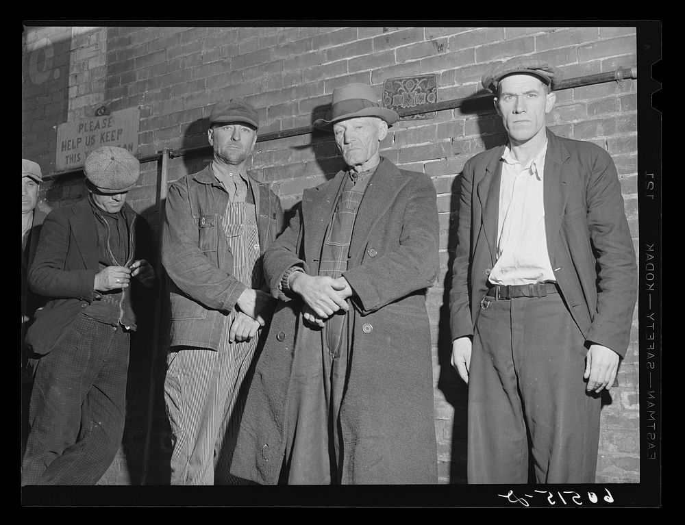 Transient men waiting in line for evening meal served at 5 p.m. at the city mission. Dubuque, Iowa. Sourced from the Library…