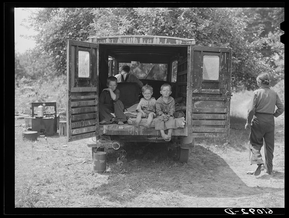 Rear of truck occupied by three children of migrant family from Arkansas. The parents sleep in a small tent. Berrien County…