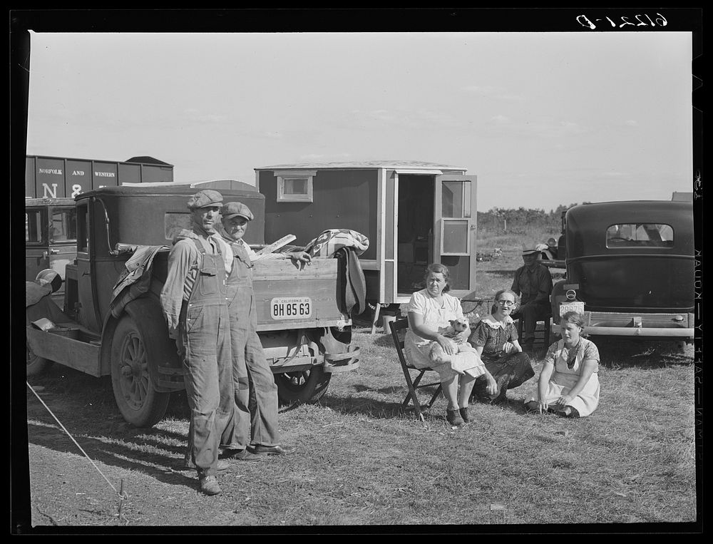 Migrant fruit workers. Berrien County, Michigan. One family has been on the road eighteen years, the other the past five…