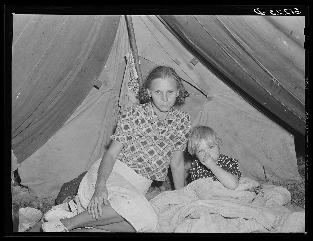 Wife and child of migrant fruit worker in their tent home. Berrien County, Michigan. Sourced from the Library of Congress.