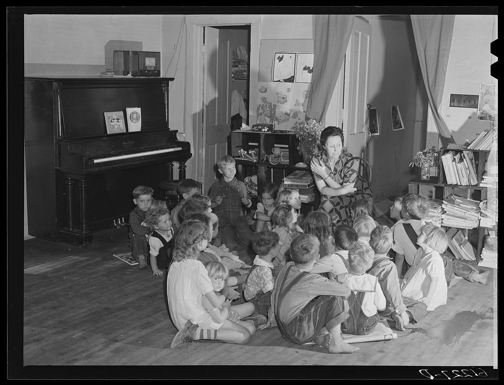 Teacher telling story to migrant children in nursery school run by Women's Council for Home Missions. Berrien County…