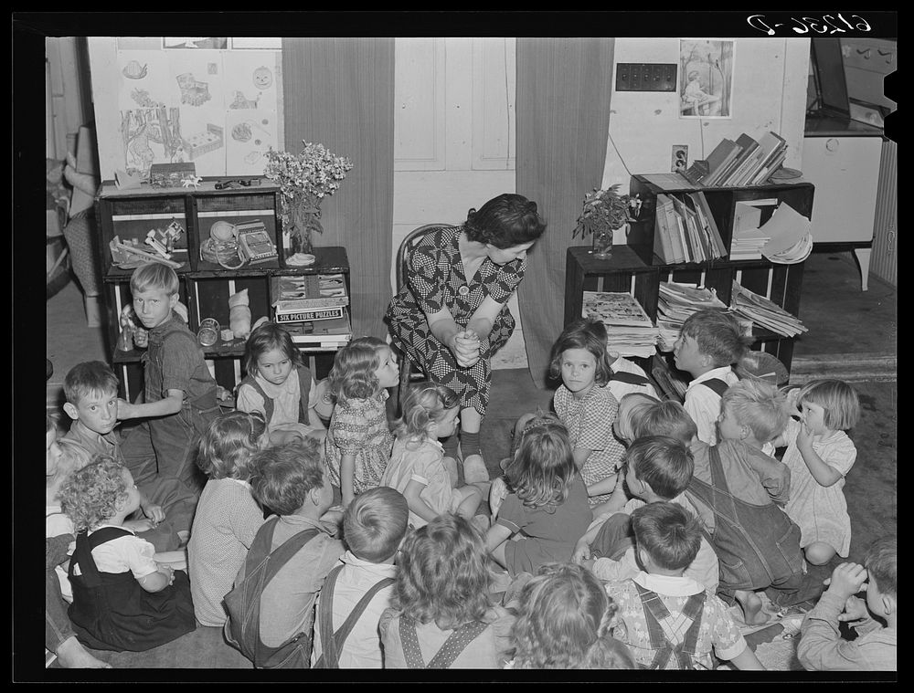 [Untitled photo, possibly related to: Teacher telling story to migrant children in nursery school run by Women's Council for…