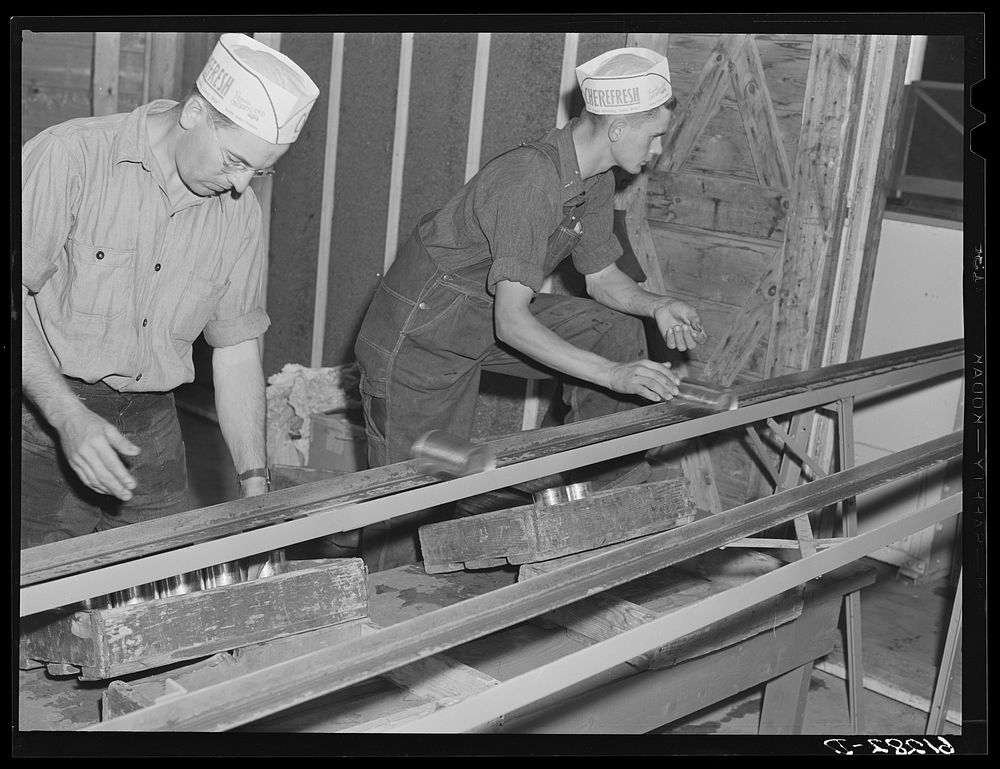 Loading boxes with cans of cherries. Canning plant, Door County, Wisconsin. Sourced from the Library of Congress.