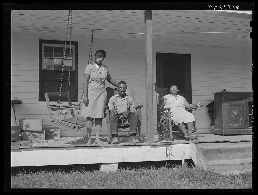Harry Handy, FSA (Farm Security Administration) borrower, with wife and daughter on front porch of their home. Saint Mary's…