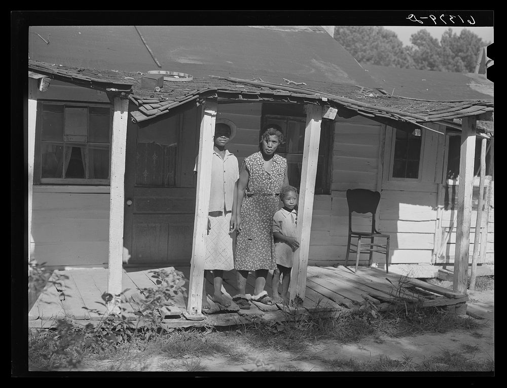 Mrs. Calip White and two of her children on front porch of their home near Scotland, Saint Mary's County, Maryland. Sourced…