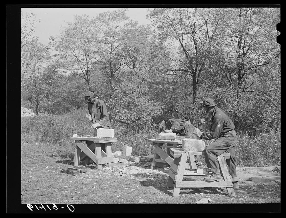 CCC (Civilian Conservation Corps) boys chopping stones for use in building charcoal burners at picnic grounds of recreation…