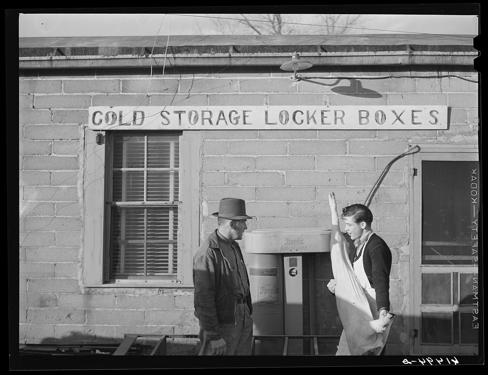 [Untitled photo, possibly related to: Farmer bringing food out of co-op cold storage lockers. This coop received a forty…