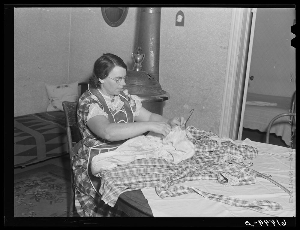 Mrs. Sauer with dress she is making. Cavalier County, North Dakota. Sourced from the Library of Congress.