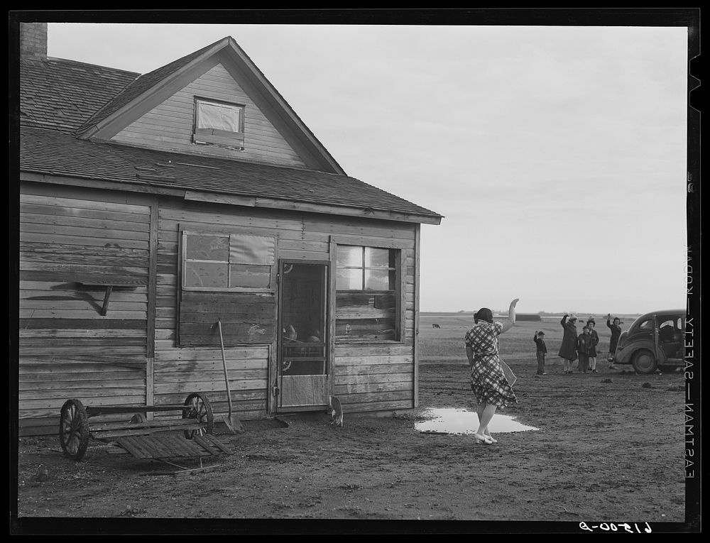 Mrs. Sauer waving goodbye to children who are going to school. Cavalier County, North Dakota. Sourced from the Library of…