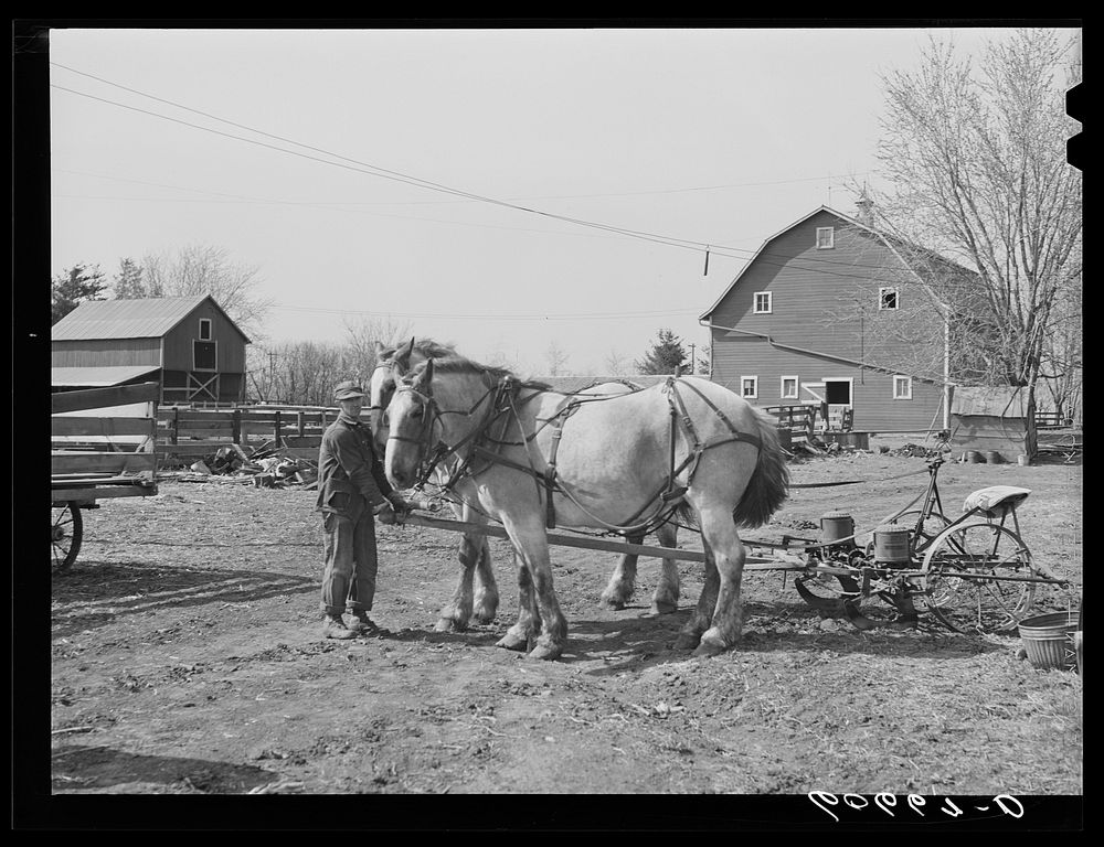 [Untitled photo, possibly related to: Filling box on two-row corn planter. Grundy County, Iowa]. Sourced from the Library of…
