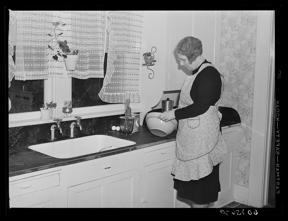 Wife of Iowa farmer starting to make a cake. Greene County, Iowa. Sourced from the Library of Congress.