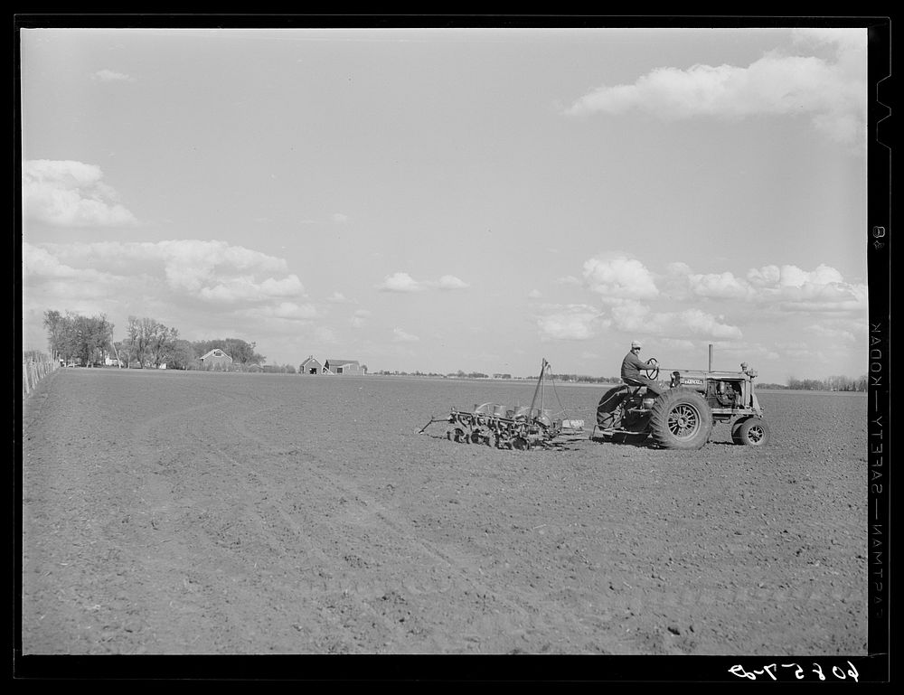 Planting corn with four-row tractor planter. Jasper County, Iowa. Sourced from the Library of Congress.