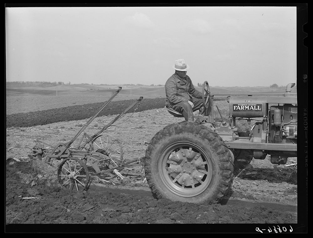 [Untitled photo, possibly related to: County agent helping farmer adjust plow. Jasper County, Iowa]. Sourced from the…