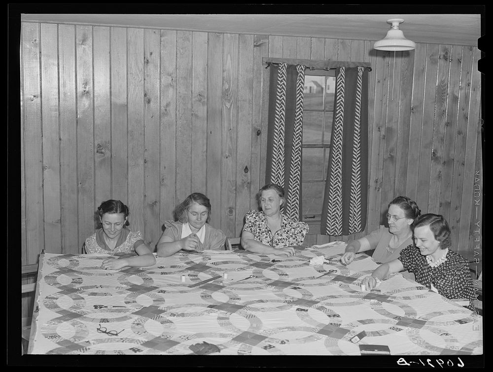 Members of the women's club making quilt. Granger Homesteads, Iowa. Sourced from the Library of Congress.