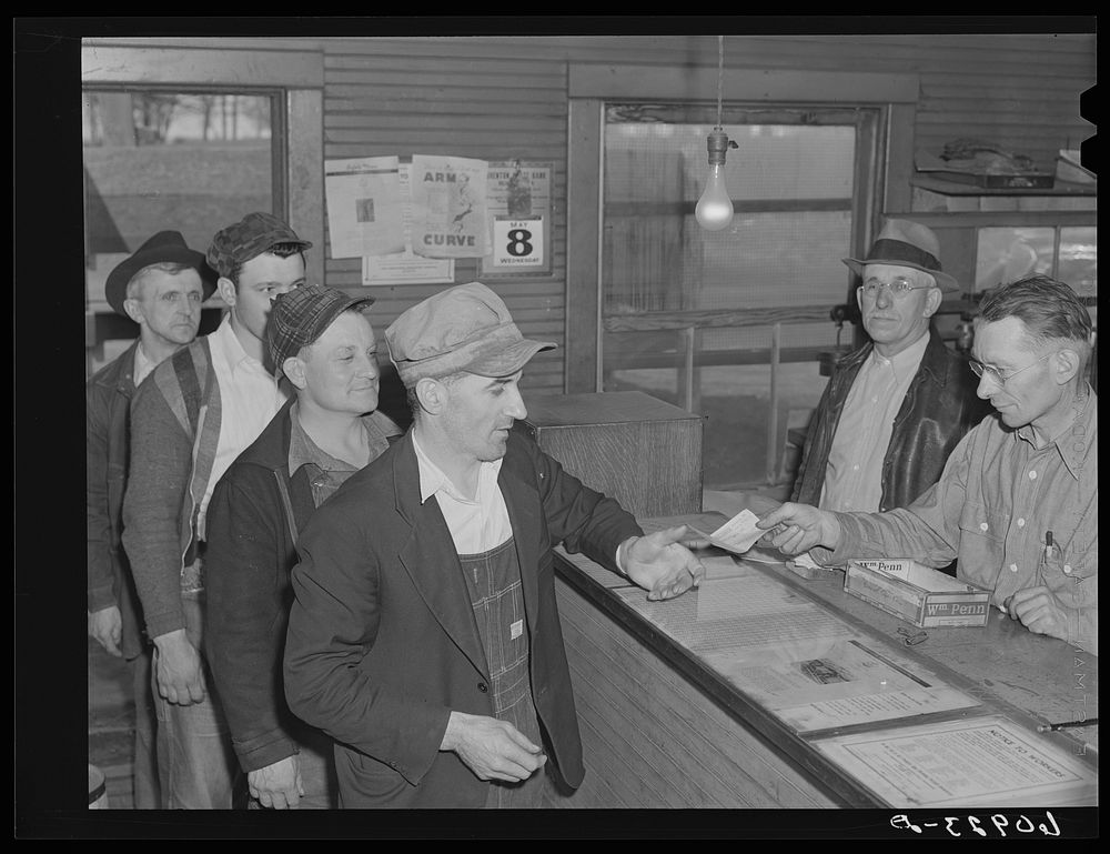Granger homesteaders receiving paycheck at coal mine office. Iowa. Sourced from the Library of Congress.
