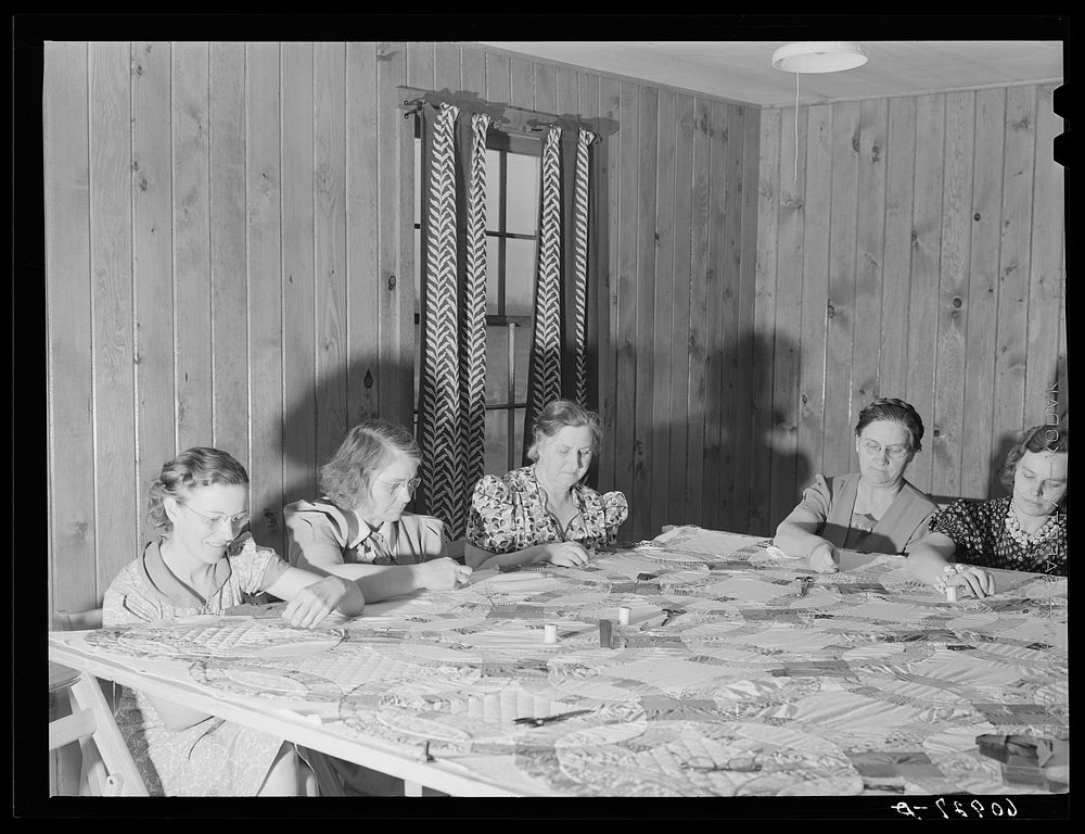 Members of the women's club making a quilt. Granger Homesteads, Iowa. Sourced from the Library of Congress.
