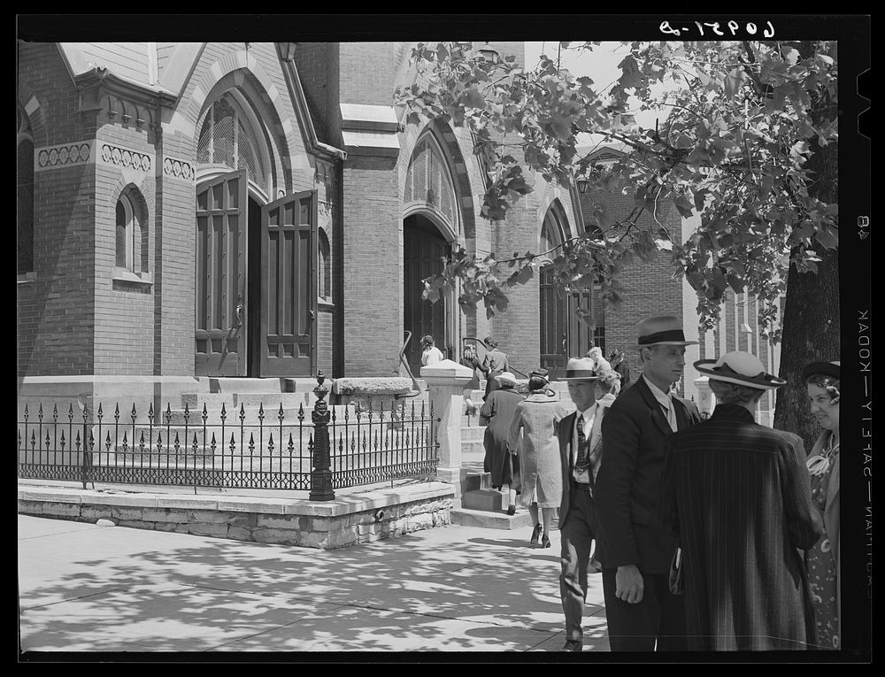 Talking in front of church on Sunday morning. Jefferson City, Missouri. Sourced from the Library of Congress.
