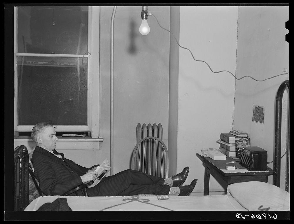 Out of state employee of Hercules powder plant in his room at Mrs. Sells boardinghouse. Radford, Virginia. Sourced from the…