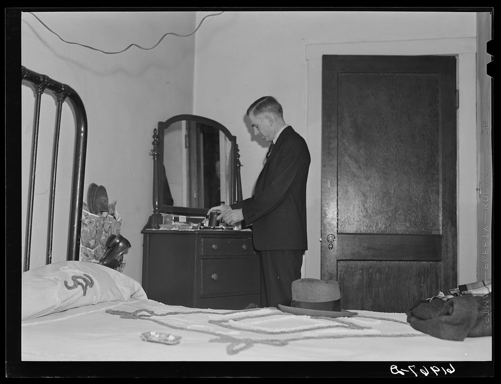 [Untitled photo, possibly related to: Out of state employee of Hercules powder plant in his room at Mrs. Sells…