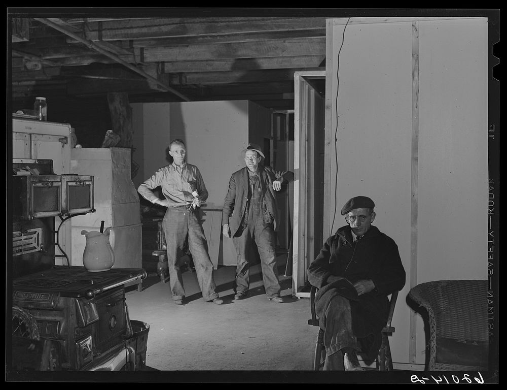 Men in the basement of Mr. Tilly's secondhand furniture store. He is fixing up living quarters for fifty. Radford, Virginia.…