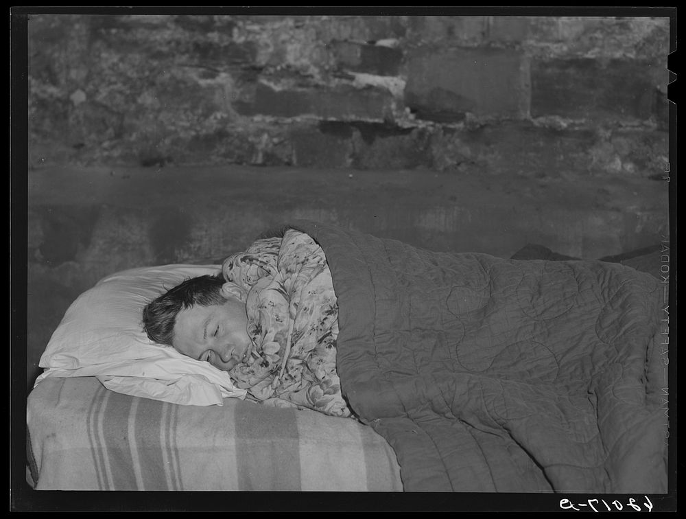 Construction worker sleeping in basement of Mr. Tilly's store. Radford, Virginia. Sourced from the Library of Congress.