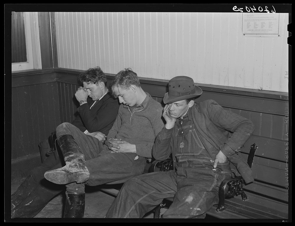 Men sleeping in railroad station, Radford, Virginia. They come in from out of town to work in the powder plant and are often…
