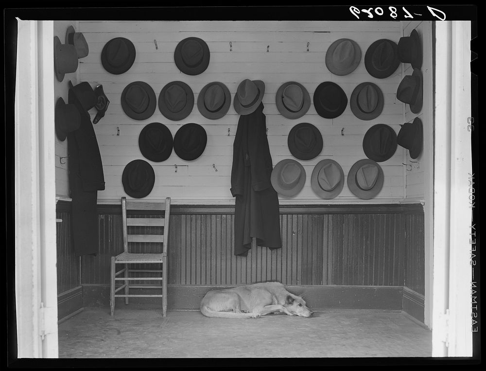 Vestibule of Baptist church during Sunday services. Hats belonging to steel and cotton mill workers. Gadsden, Alabama.…