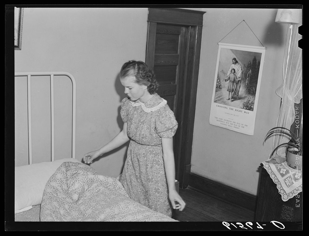 Farm girl making bed. McIntosh County, North Dakota. Sourced from the Library of Congress.