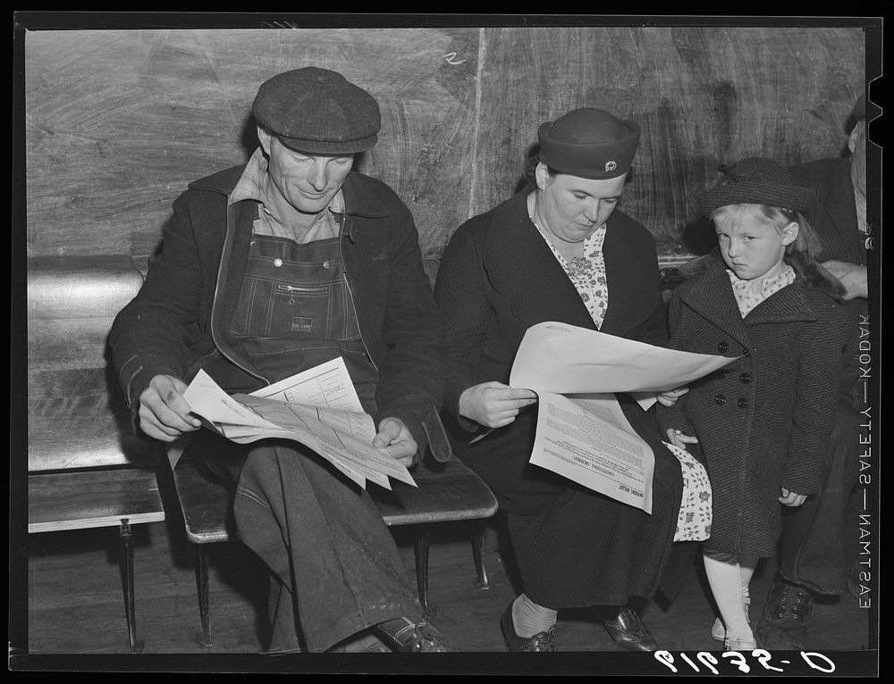 Farm couple reading over ballots. Election day, November 1940. McIntosh County, North Dakota. Sourced from the Library of…