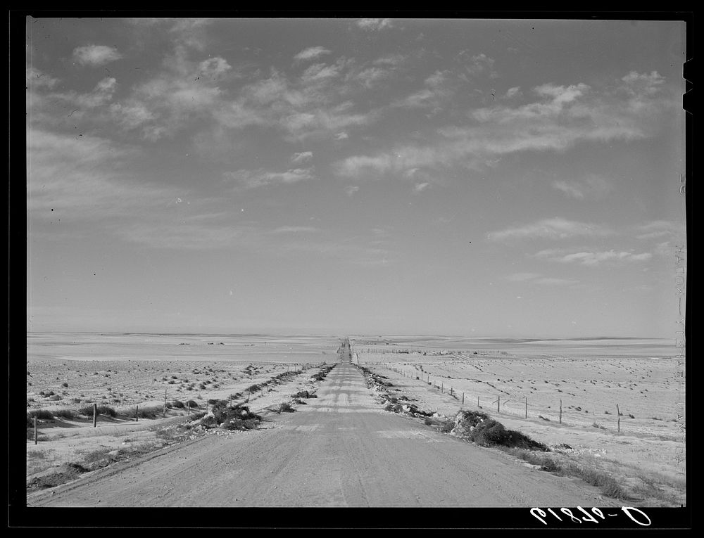 U.S. Highway no. 18 through Shannon County, South Dakota. Tumbleweeds lining edges of road. Sourced from the Library of…