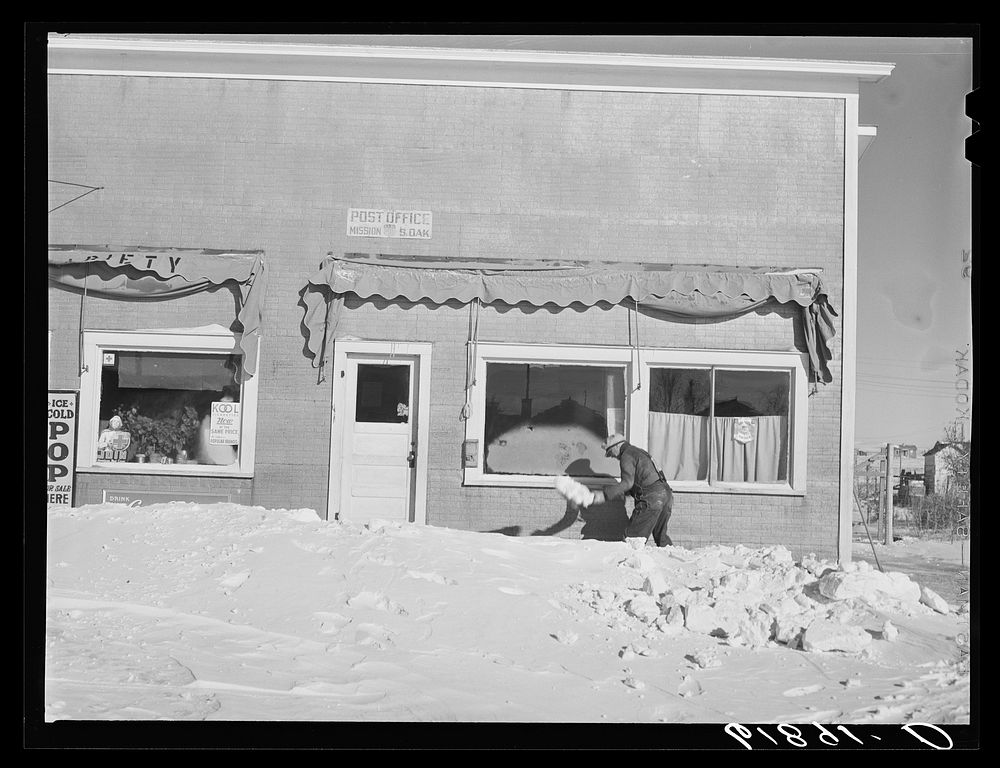 Shoveling snow in front of post office. Mission, South Dakota. Sourced from the Library of Congress.