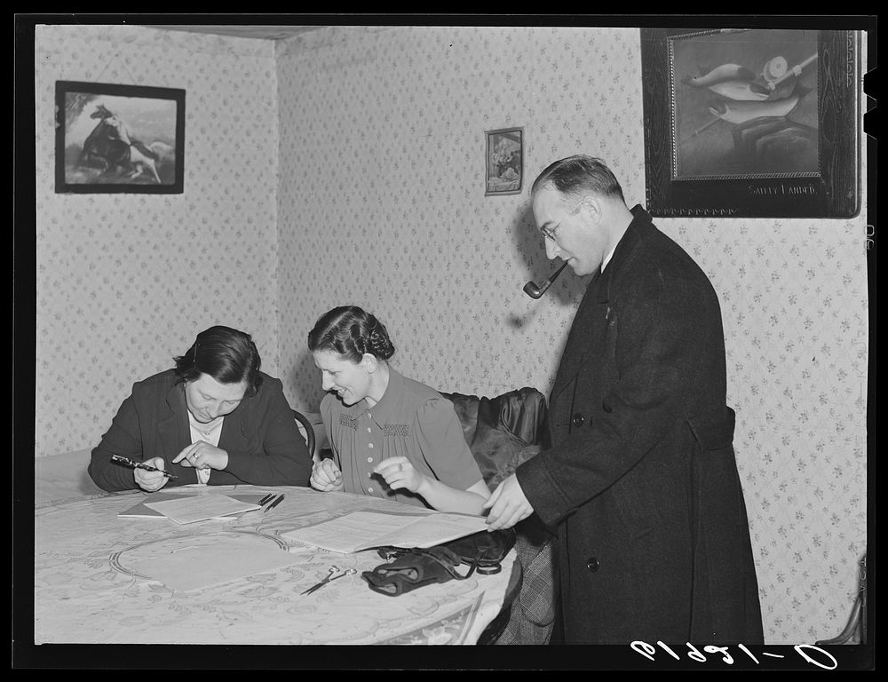 Home supervisor and county supervisor helping wife of FSA (Farm Security Administration) borrower with account book. Labette…