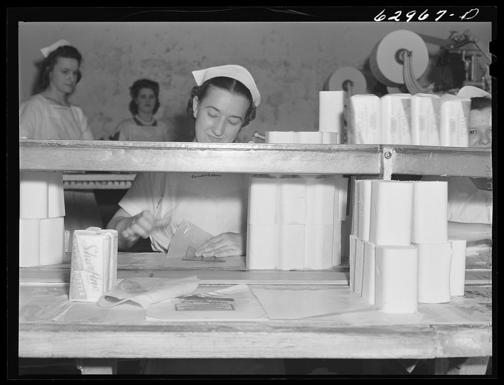 [Untitled photo, possibly related to: Butter going through machine which cuts it into quarter-pound sections. Land O'Lakes…