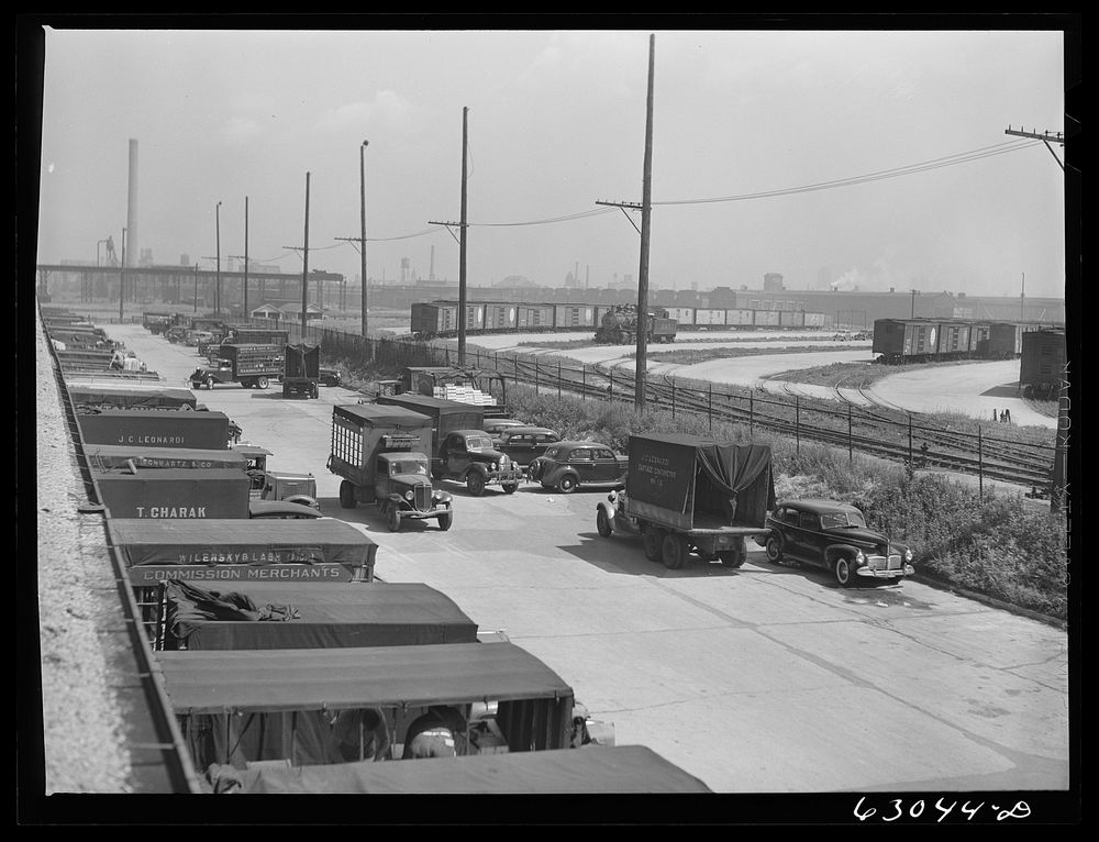 Trucks of commission merchants lined up outside fruit terminal to haul produce market what has been bought at auction.…