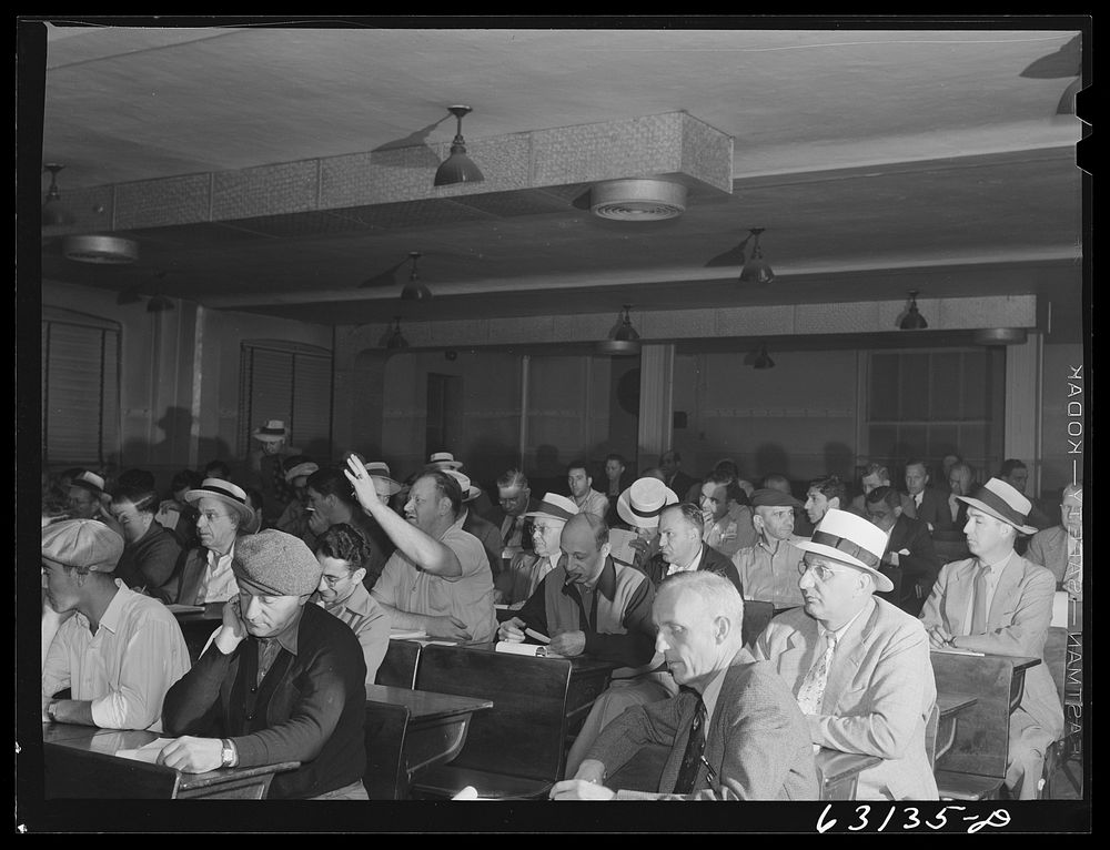 Commission merchants and their agents at early morning auction at fruit terminal. Chicago, Illinois. Auctions are held every…