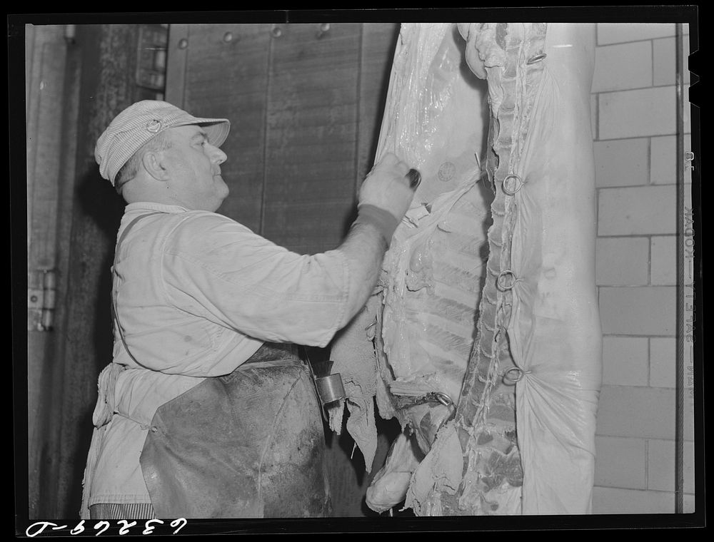 Putting government stamp on carcass of inspected beef. Hormel plant, Austin, Minnesota. Sourced from the Library of Congress.