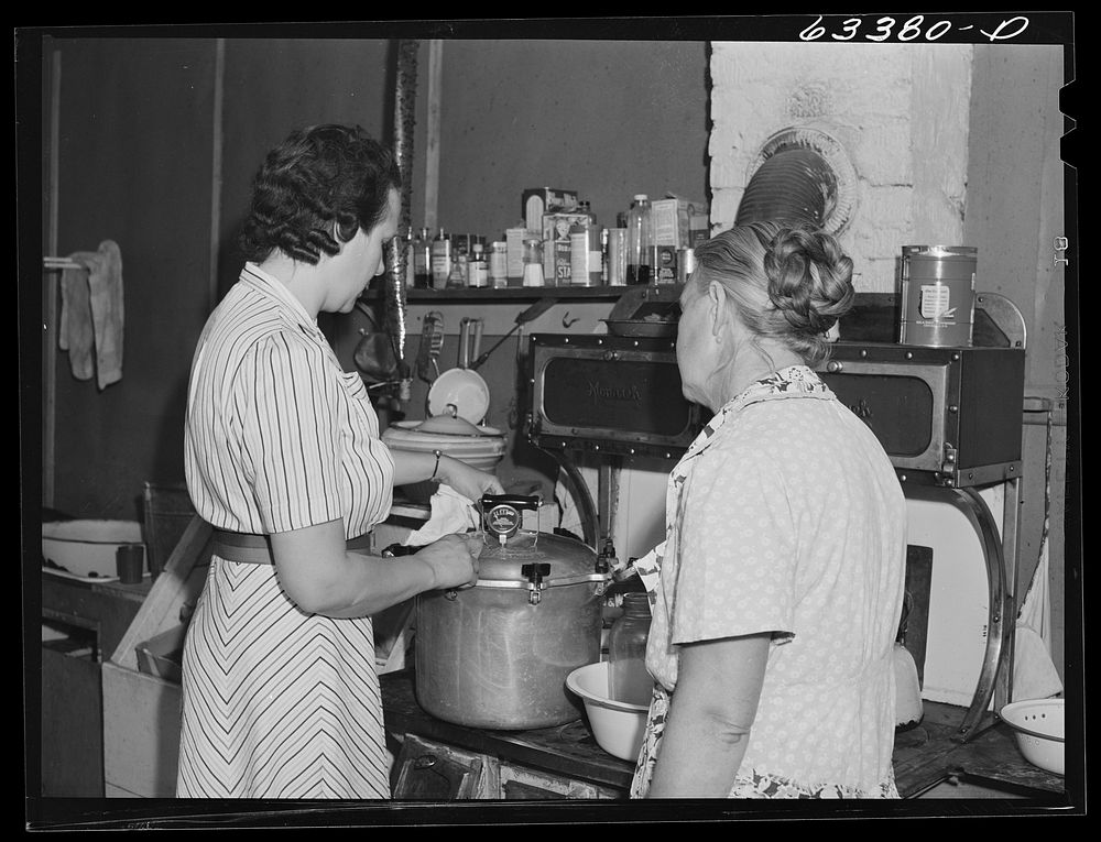 Home supervisor showing FSA (Farm Security Administration) borrower how to use pressure cooker. Mille Lacs County…