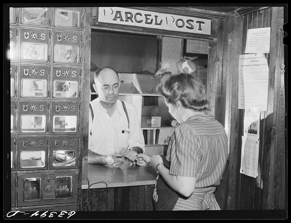 Buying stamps in post office. Siren, Wisconsin. Sourced from the Library of Congress.